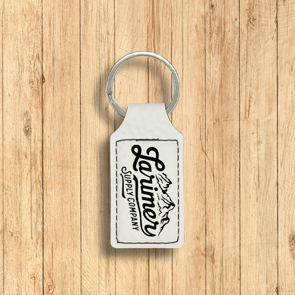 Larimer Supply Company premium leatherette keychain in golfball white